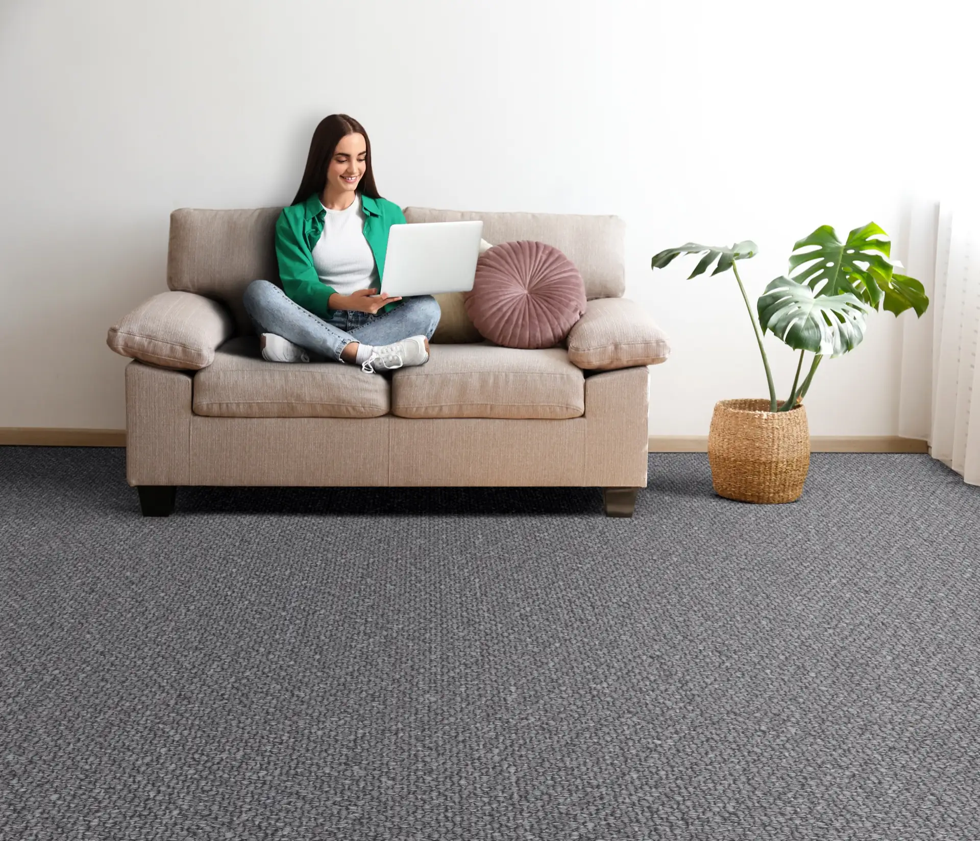 Woman relaxing on a sofa over a grey Gobi carpet