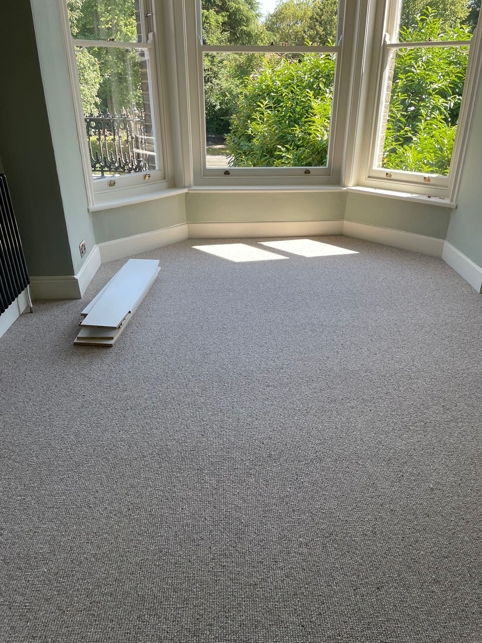 Bedroom carpet installation with bay window