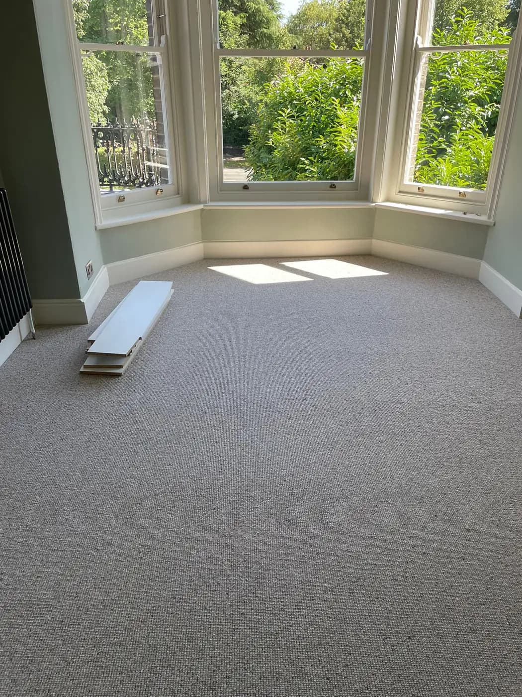 Bedroom carpet installation with bay window